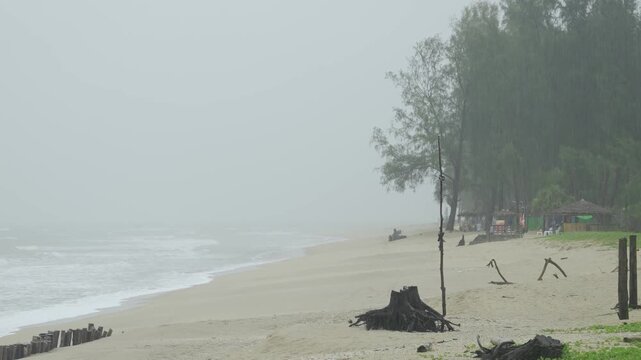 climate change concept view of heavy storm and wind blowing white sand beach with huge wave in sea hit the sand beach in daytime, storming weather landscape at beach