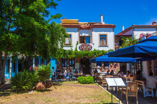 Ayvalik - Turkey, May 17, 2026, Traditional Stone Restaurant  with Blue Umbrellas on Cunda Island