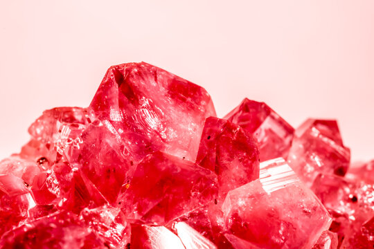 Amethyst red crystals. Gems. Mineral crystals in the natural environment. Texture of precious and semiprecious stones. Seamless background with copy space colored shiny surface of precious stones.