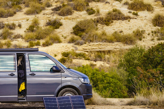 Portable solar photovoltaic panel, charging battery at camper van vehicle.