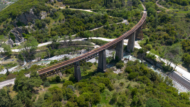 Aerial Drone View of Curved Historic Gorgopotamos Railway Bridge Viaduct in Greece