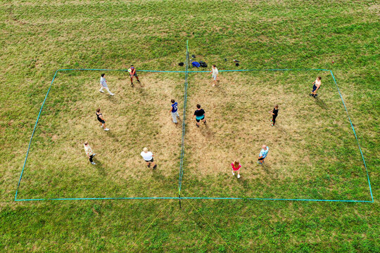 Herzogenaurach, Germany - 26 July 2025: Aerial view of people playing volleyball on a grass court during the Open Beatz Festival with green fields and summer light.
