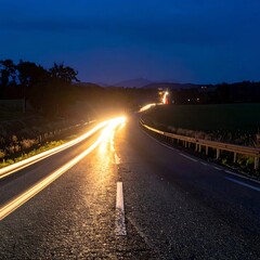 Obraz premium Dark Highway with Car Light Trails.