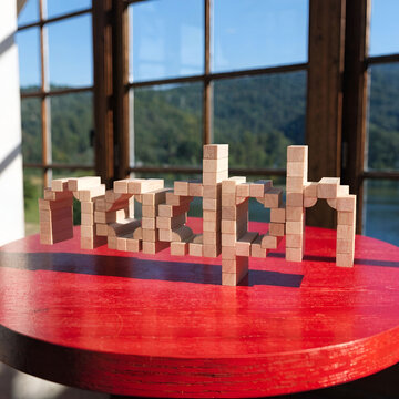 the word nadph is made of wooden cubes on a red table