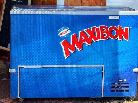 Venice, Italy - May 20, 2026: Nestle MAXIBON ice cream freezer with blue exterior and prominent branding displayed in a retail setting