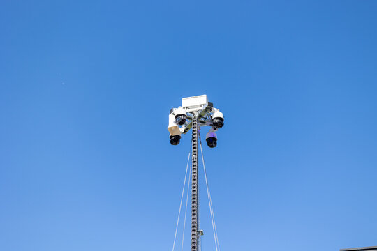 Security cameras on tall pole monitoring public space