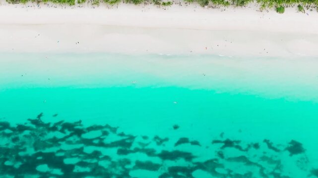 Ocean waves crashing over powdery white sand beach. Boracay, Philippines.