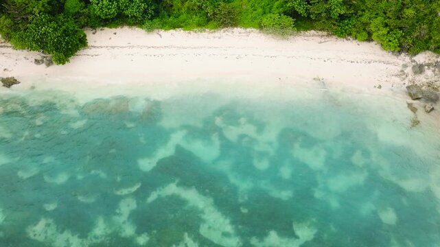Tropical beach with turquoise sea waters and corals. Ilig Iligan Beach. Boracay, Philippines.