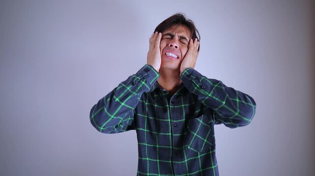 Disappointed and stressed young man looking directly at camera with sad expression