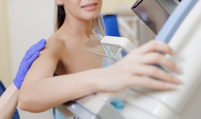 Woman receiving mammogram screening during clinic visit, white light © Parilov