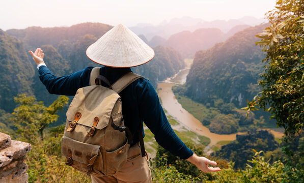 Traveler enjoying scenic view of Ninh Binh's karst mountains and river