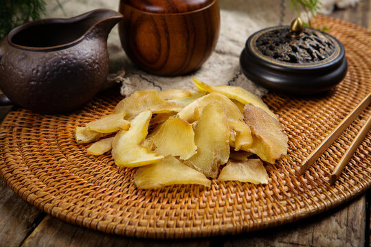 Dried polygonatum rhizome slices with traditional teaware on woven tray