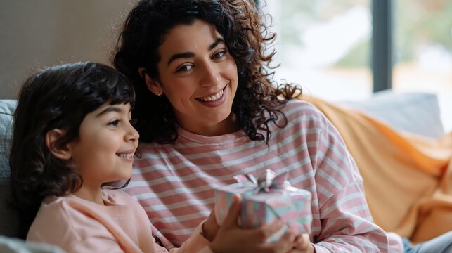Mother and son relaxing together on a sofa at home
