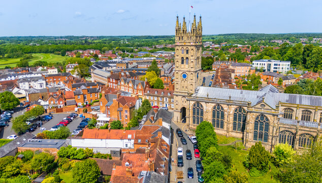 An aerial view of the UK town of Warwick, with the main high street, the Cathedral and the racecourse in the background