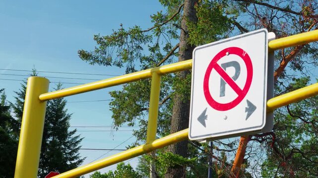 No parking regulatory sign with arrows on yellow metal gate
