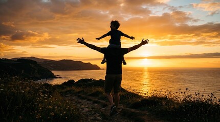 Fototapeta premium Silhouette of a father carrying his young son on his shoulders while watching a beautiful sunset over the ocean from a cliff top