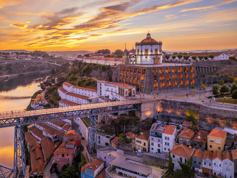 Drone view of Mosteiro da Serra do Pilar in Vila Nova de Gaia, Portugal, above the Douro River and Dom Luis I Bridge at sunrise