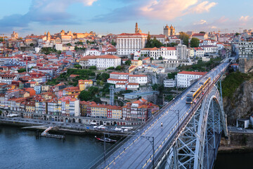 Obraz premium Sunrise morning view of Porto and Ribeira with a tram along Dom Luis I Bridge above the Douro River in Portugal