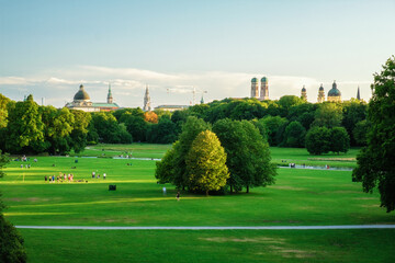 Naklejka premium Munich, Germany skyline from Englischer Garten with Frauenkirche, Neues Rathaus, Theatinerkirche, Bavarian State Chancellery and park lawns