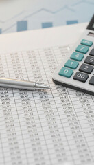 Close-up of a calculator and pen on financial papers, symbolizing business, finance, and accounting, with a clean and professional aesthetic