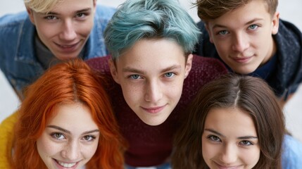 Obraz premium Group of teenagers looking down at camera outdoors, friendship and youth energy