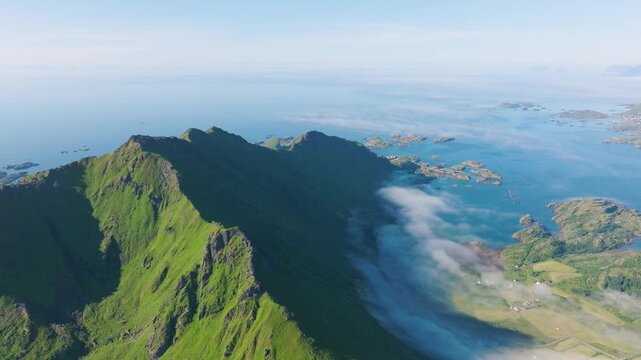 Drone view of a fjord in Leknes, Lofoten Islands, Norway. Panoramic aerial view of the northern summer. Scenic arctic landscape with high hills, ocean and northern nature.