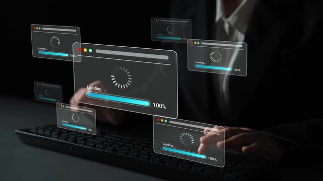 Business Professional Working on a Computer with Multiple Loading Screens Displayed in a Dark Environment During a Data Processing Task Gluon.