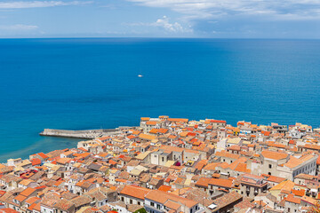 Obraz premium Drone view historic European coastal town with terracotta roofs by the sea