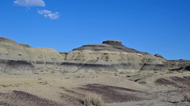 landscape features the unique geological formations of the Bisti De-Na-Zin Wilderness Area in New Mexico