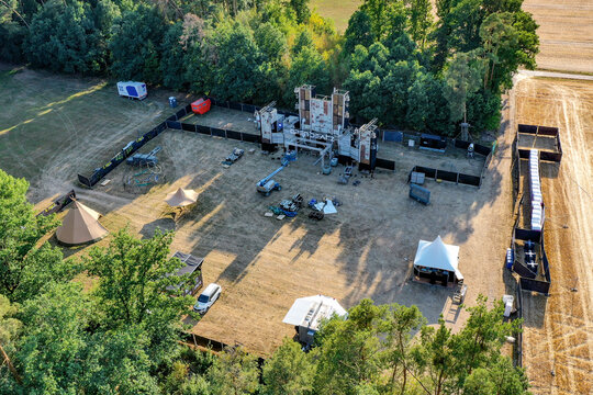 Herzogenaurach, Germany - 22 July 2022: Aerial view of the Open Beatz Festival stage setup under construction surrounded by lush green trees and fields.