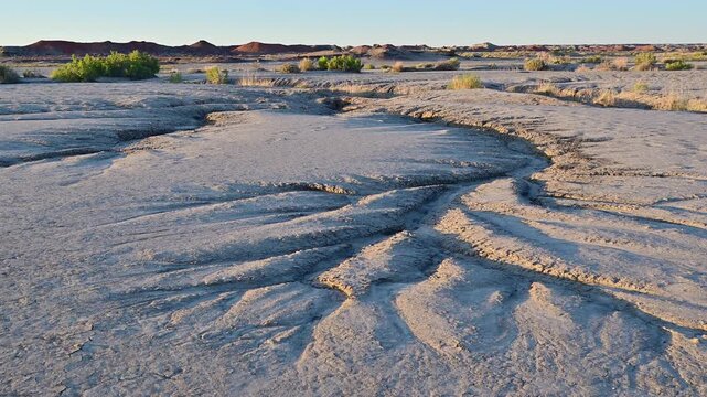 landscape features the unique geological formations of the Bisti De-Na-Zin Wilderness Area in New Mexico