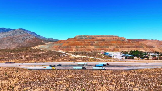 Moving to the parking lot for trucks near the lively highway. View on the Mountain Pass Rare Earth Mine located near San Bernardino County, California, USA.