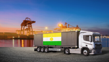 International Shipping with Niger Flag: A modern cargo truck carrying a shipping container marked with the flag of Niger stands ready for transport at a bustling port during twilight. © bao