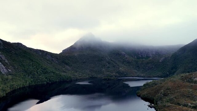 Up aerial view over Dove lake Cradle Mountain national park of Tasmania sunrise foggy.