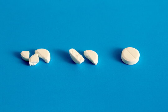 There are several white tablets on a blue background.