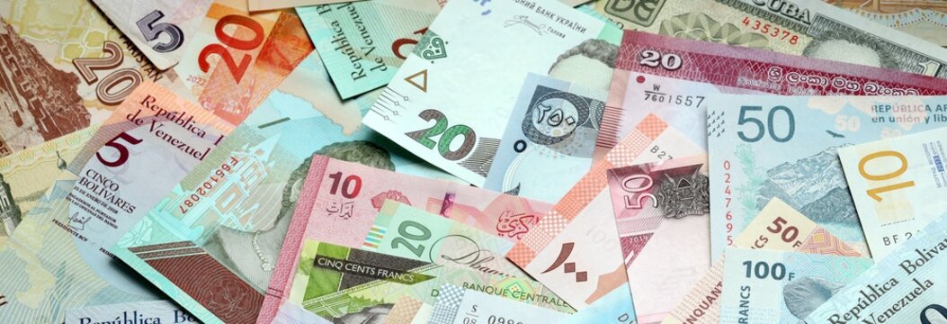 Big amount of money bills of various currencies. Assortment background of international cash
