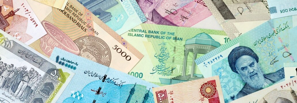 Iranian rial money banknotes bunch on table. Iran bills of IRR currency close up