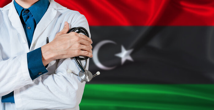 Doctor with stethoscope on Libya flag. Doctor holding stethoscope on Libya flag