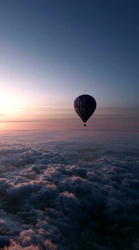 Hot air balloon floating above clouds at sunrise