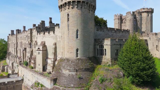 A rising view of the outside of Caesar's Tower at Warwick Castle showing the intricate details of the castles wall
