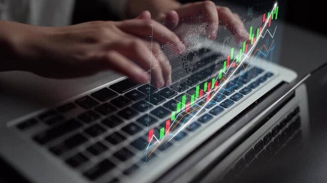 A close-up view of hands working on a laptop, enhanced with digital graphs displaying stock market trends, ideal for investment and financial analysis visuals. Copula