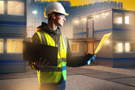 Engineer reviews plans at modular site office, construction inspection and project management