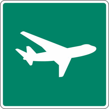 A green and white airplane sign indicating an airport or flight direction