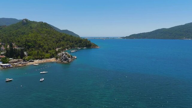 Marmaris, Turkey. Aerial drone view over a deeply indented fjord-like bay, where forested mountains plunge into turquoise Mediterranean water, clear summer sky. Aerial View
