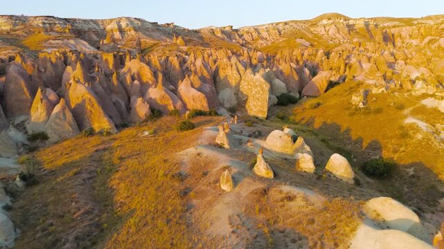 Goreme, Nevsehir, Turkey. Devrent Valley fairy chimney formations, aerial panoramic view at golden hour sunset over eroded volcanic tuff landscape. Aerial View