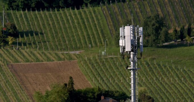 Wireless Communication Equipment Situated Over Lush Agricultural Fields With Expansive Network Coverage