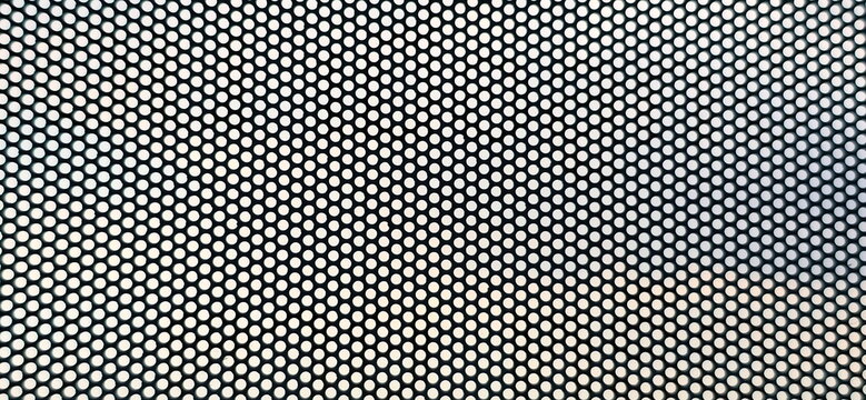 An enlarged image of a see-through sticker, which has small perforations throughout the sheet. One Way Vision, thick PVC material with small perforations. Similar to perforated metal plate.
