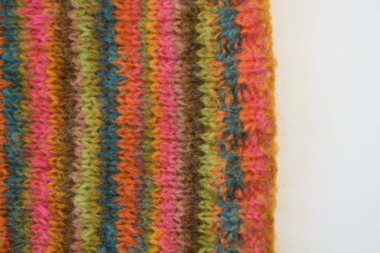 pice of hand knitting on knitting needles colourful stripes 