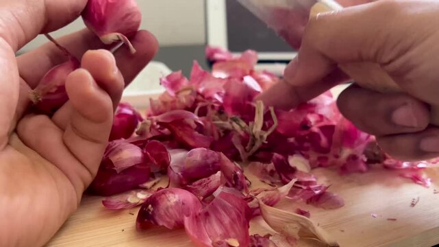 woman hands with shallot, Hand peeling fresh raw shallots on a wooden board And full of shallots skin peels
