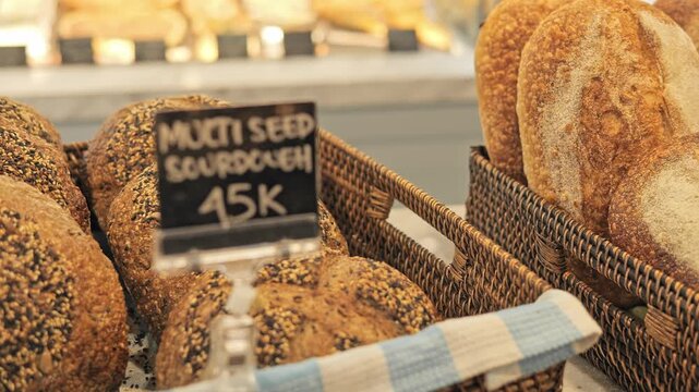 Rustic shelf with artisan bread display shelf filled with handmade loaves and golden crust Bakery shelf shows fresh sourdough selection organic texture rustic food concept and warm bakery atmosphere
